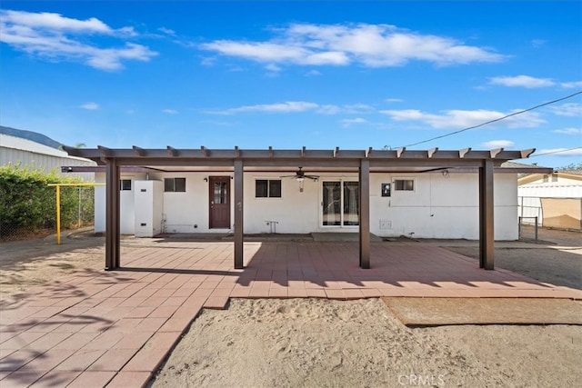 rear view of property featuring a patio area and ceiling fan