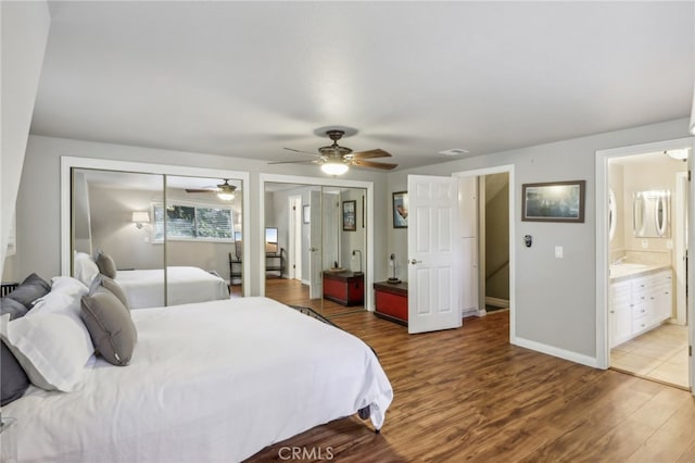 bedroom featuring ensuite bathroom, hardwood / wood-style flooring, sink, and ceiling fan