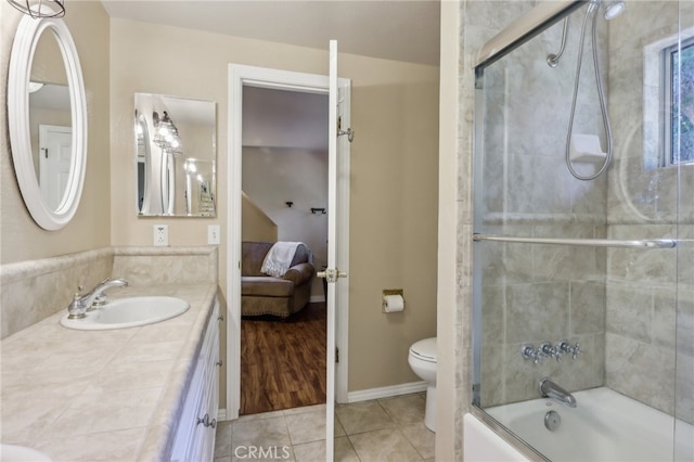 full bathroom featuring vanity, enclosed tub / shower combo, tile patterned floors, and toilet