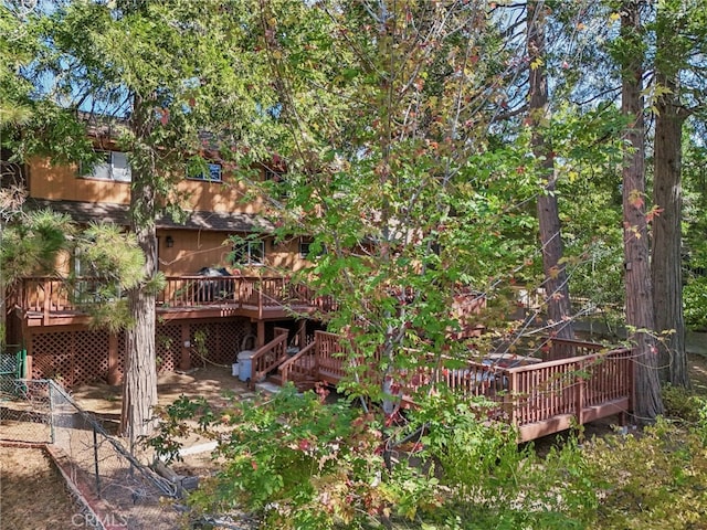 back of house with a wooden deck