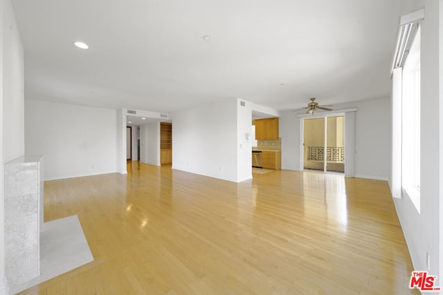 unfurnished living room with light hardwood / wood-style flooring and ceiling fan