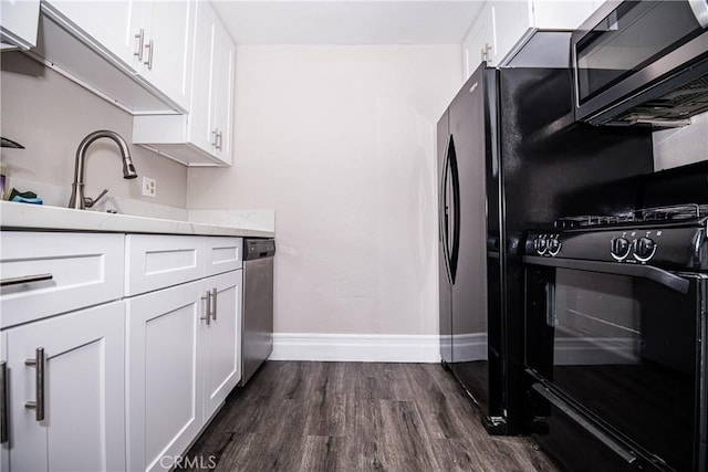 kitchen featuring white cabinets, dark hardwood / wood-style floors, and appliances with stainless steel finishes