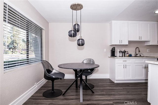 dining space featuring dark hardwood / wood-style floors and sink