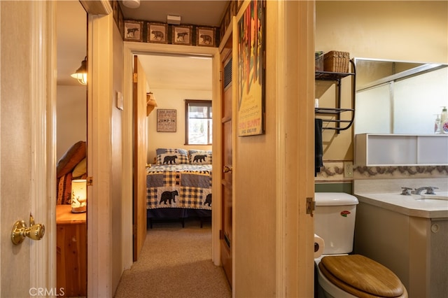 bathroom with toilet and vanity