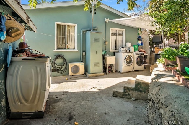 back of property featuring a patio, washer and dryer, and ac unit