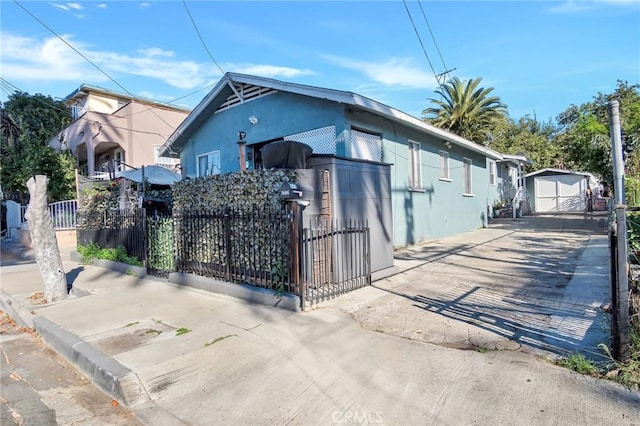 view of side of property with a garage and an outbuilding