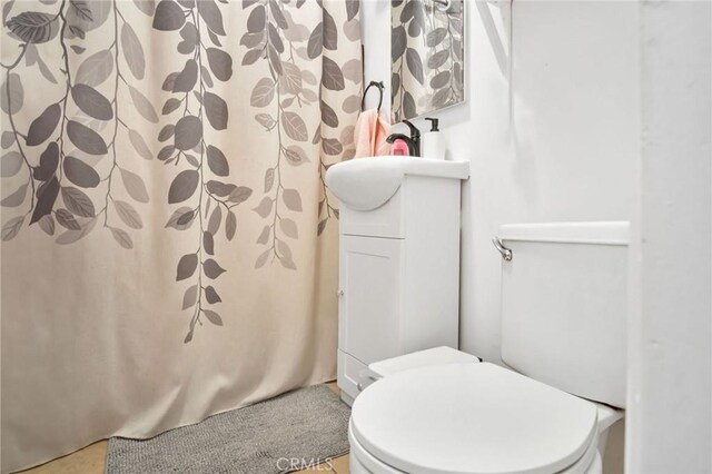 bathroom featuring toilet and vanity