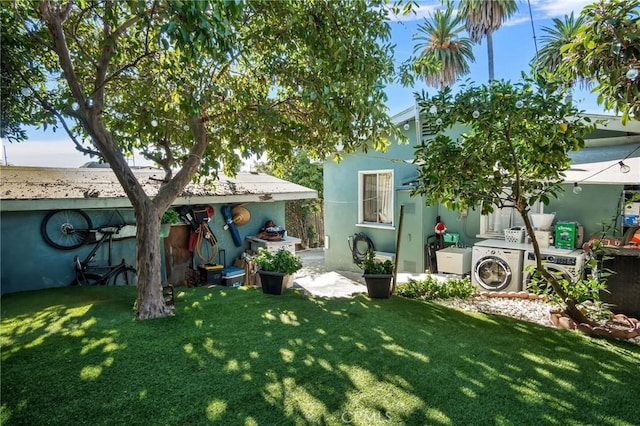 rear view of property featuring washer / clothes dryer and a lawn