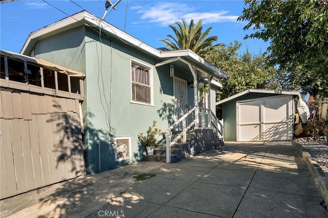 exterior space featuring a patio and a shed