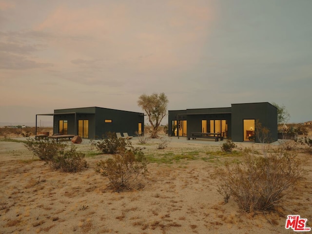 view of back house at dusk