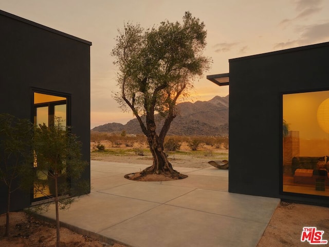 patio terrace at dusk with a mountain view