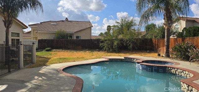 view of pool featuring a patio, an in ground hot tub, and a lawn