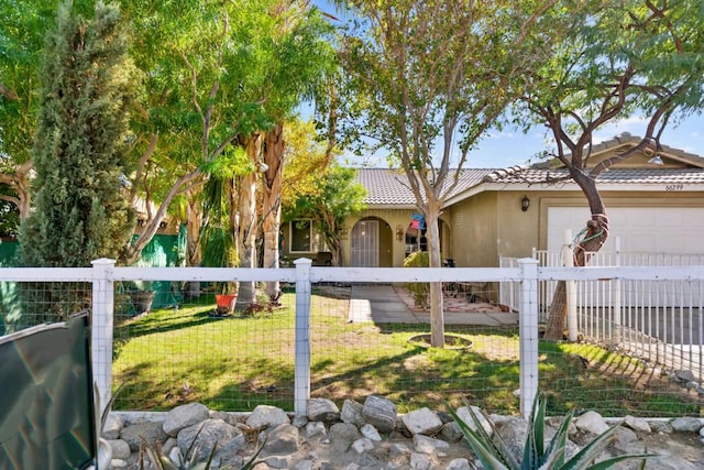 exterior space featuring a garage and a front lawn