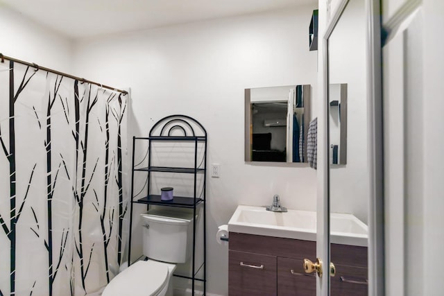 bathroom featuring vanity, toilet, and a shower with curtain