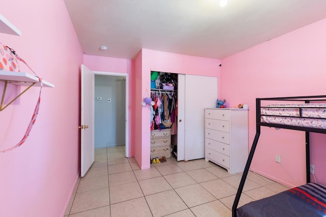 tiled bedroom with a closet