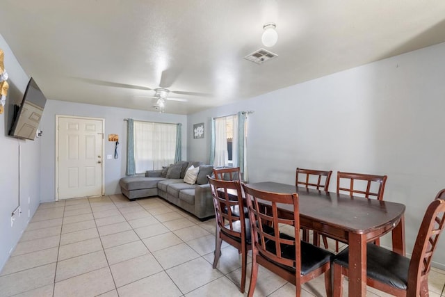 tiled dining area featuring ceiling fan