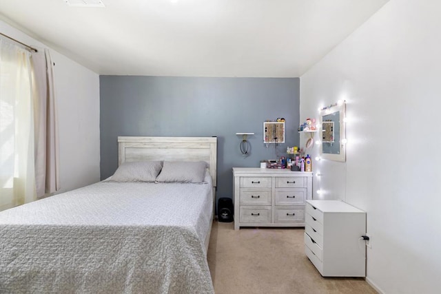 bedroom featuring light colored carpet