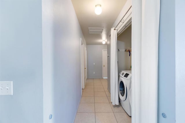 clothes washing area featuring light tile patterned flooring