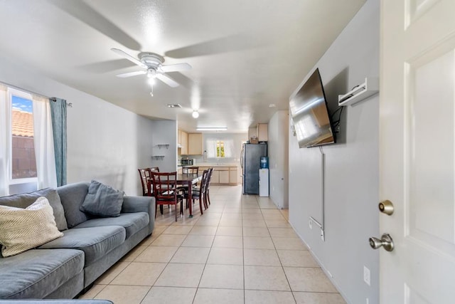 living room with ceiling fan and light tile patterned floors