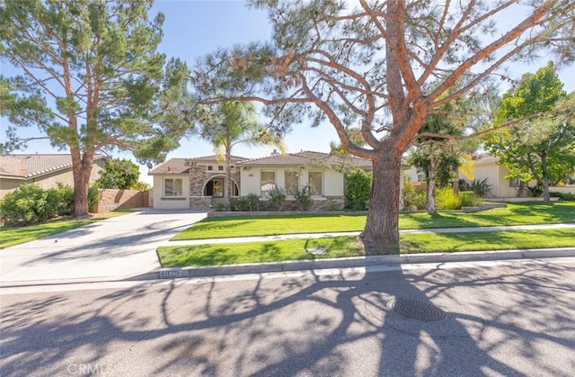 mediterranean / spanish-style house featuring a front yard