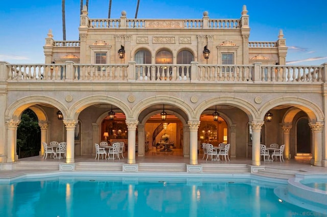 rear view of property with a patio and a balcony