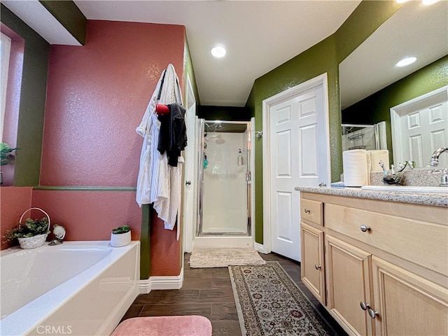 bathroom with vanity, shower with separate bathtub, and hardwood / wood-style flooring