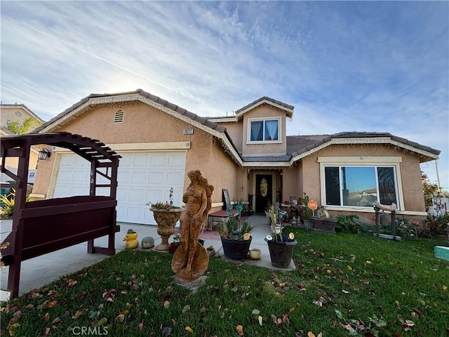 view of front of property with a front yard and a garage