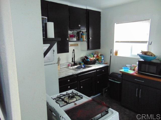 kitchen with sink and white gas range oven