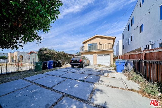 exterior space featuring a balcony and a garage