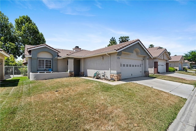 ranch-style house featuring a front yard and a garage