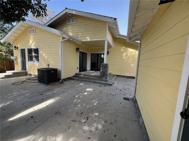 rear view of property featuring a patio area and central AC unit