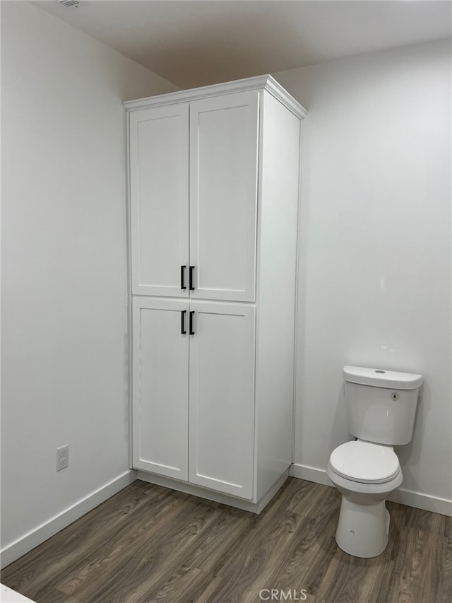 bathroom with wood-type flooring and toilet