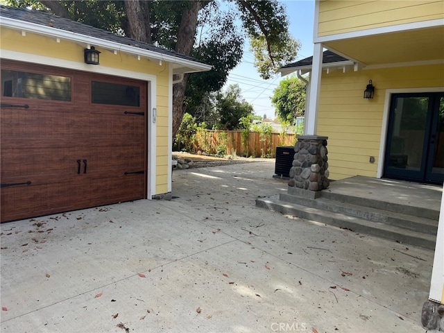 view of patio / terrace with central AC and a garage