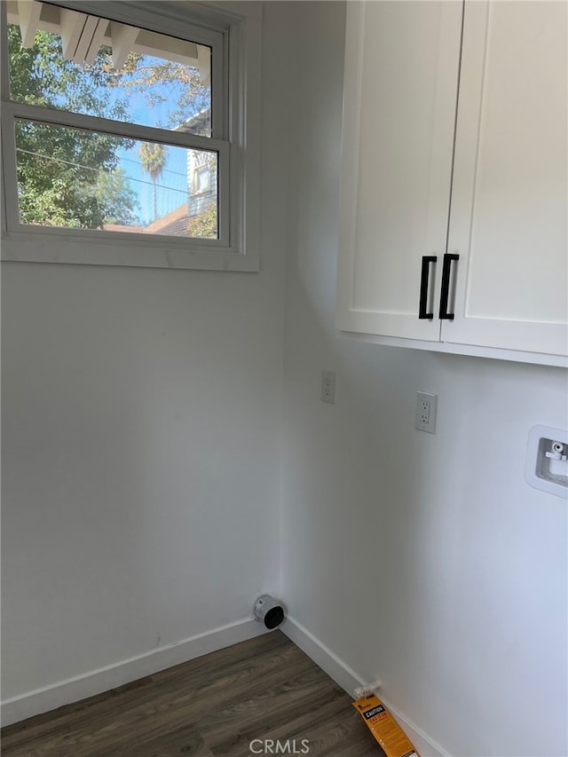 washroom with dark hardwood / wood-style flooring, cabinets, and washer hookup