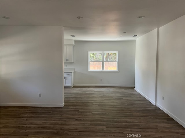 unfurnished room featuring dark hardwood / wood-style flooring