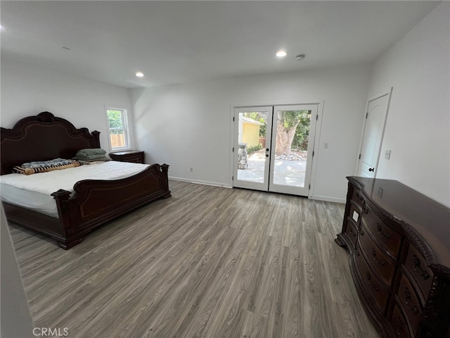 bedroom featuring access to exterior and light wood-type flooring