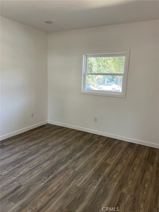 spare room featuring dark hardwood / wood-style flooring