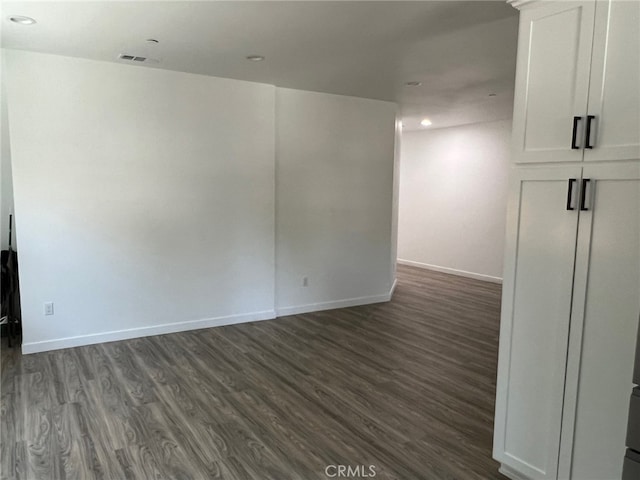 spare room featuring dark hardwood / wood-style floors