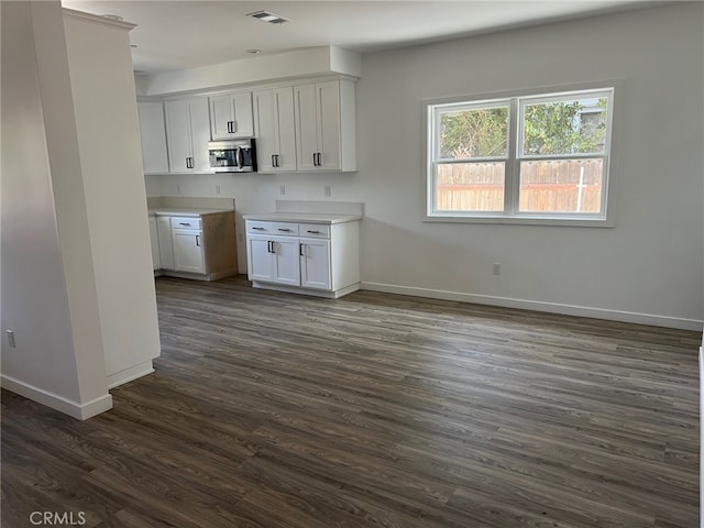 kitchen with white cabinetry and dark wood-type flooring