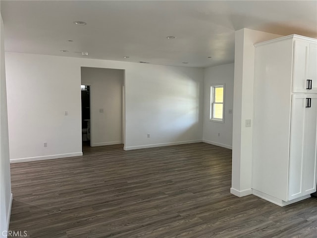 empty room featuring dark wood-type flooring