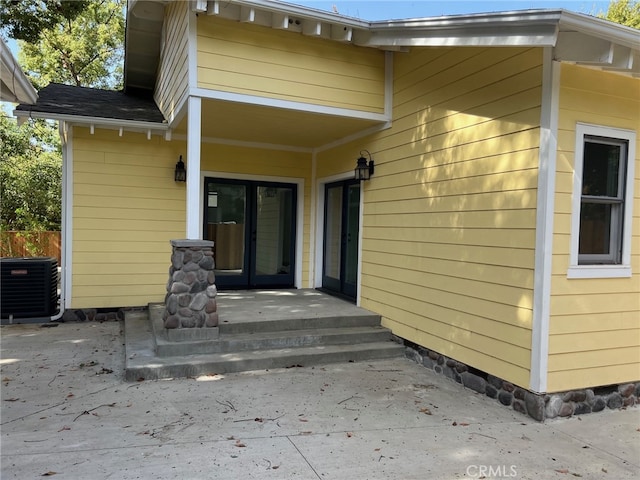 entrance to property with central AC and a patio