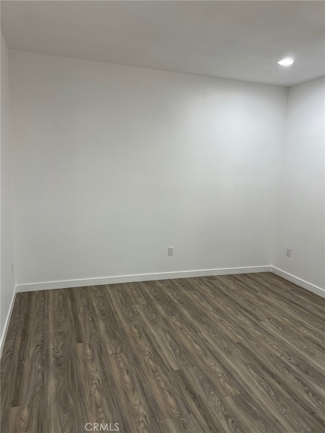 unfurnished room with dark hardwood / wood-style floors