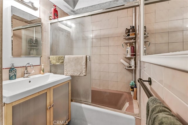 bathroom featuring vanity and combined bath / shower with glass door