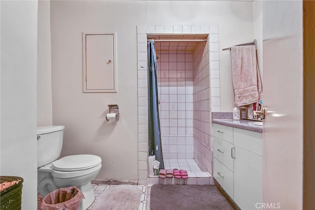 bathroom with vanity, a shower with curtain, toilet, and tile patterned flooring