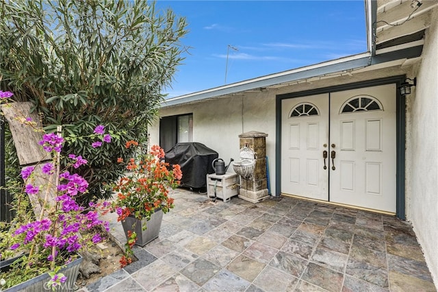 property entrance with a patio