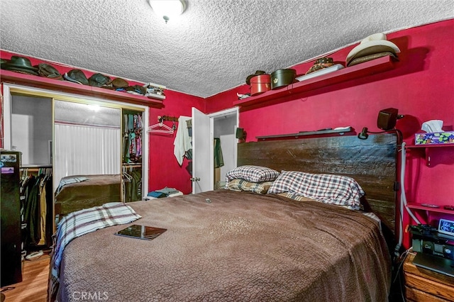 bedroom with wood-type flooring and a textured ceiling