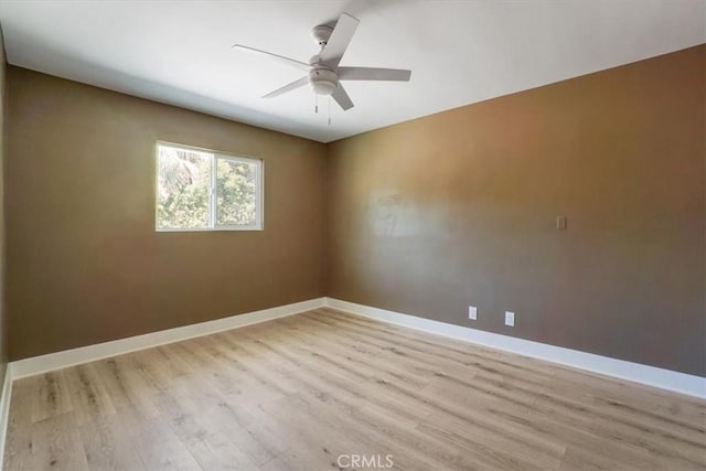 empty room featuring ceiling fan and light hardwood / wood-style flooring