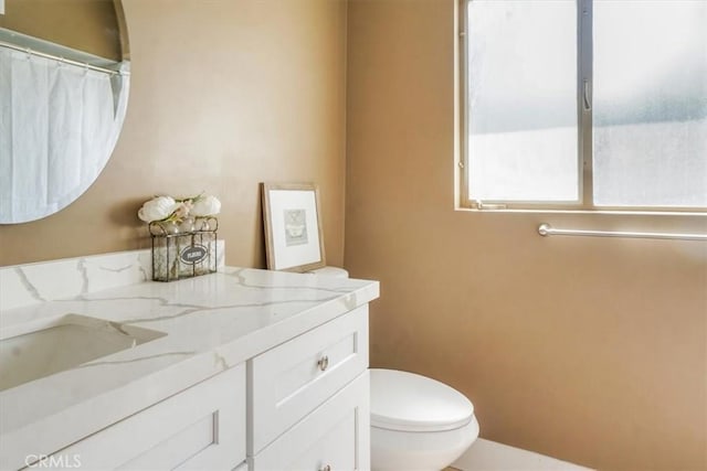 bathroom featuring toilet and vanity