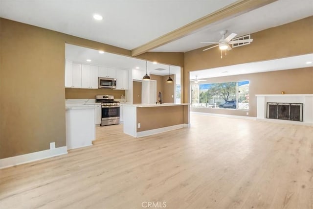 unfurnished living room featuring ceiling fan, sink, lofted ceiling with beams, and light wood-type flooring