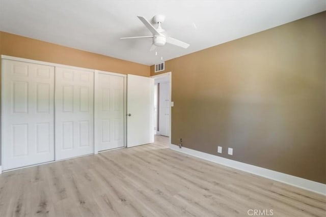 unfurnished bedroom with ceiling fan and light hardwood / wood-style flooring